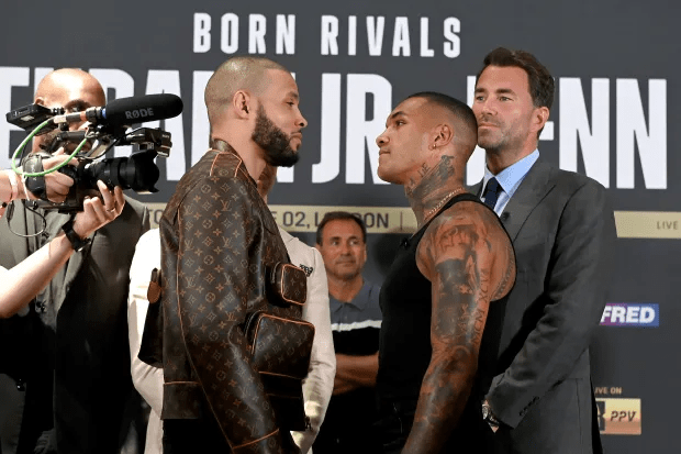 two men standing in front of a sign that says born rivals