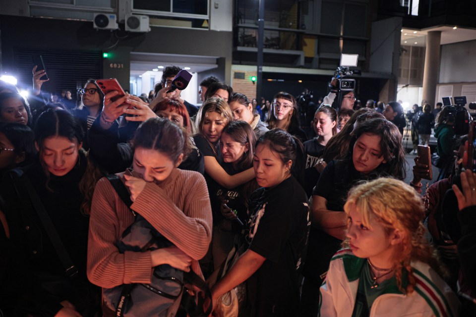 a crowd of people are gathered in front of a building with the number 6831 on it