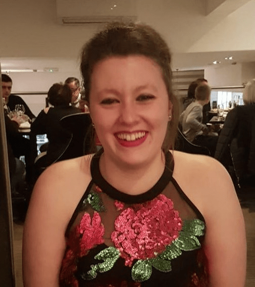 a woman in a sequined dress is smiling for the camera