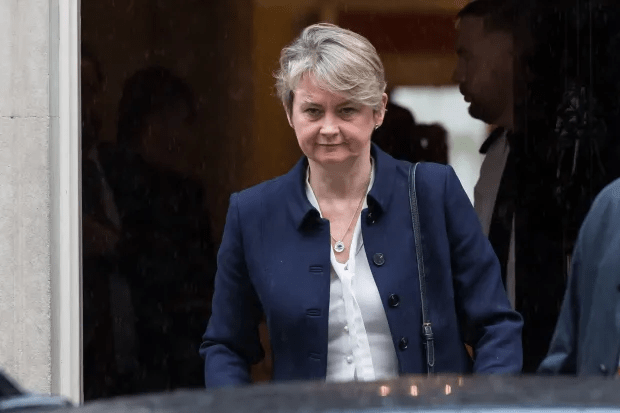 a woman wearing a blue jacket and a white shirt