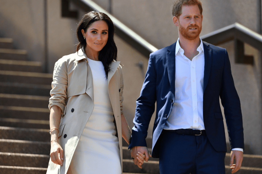 Prince Harry and his wife Meghan walk down the stairs of Sydney's iconic Opera House to meet people on October 16, 2018