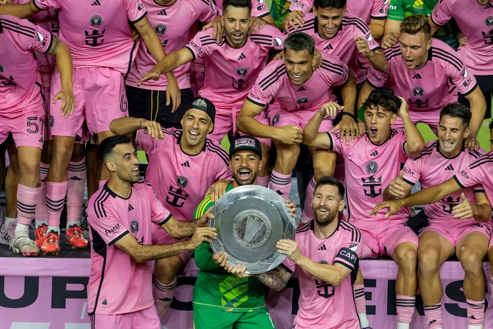 a group of soccer players wearing pink jerseys with the number 5 on them