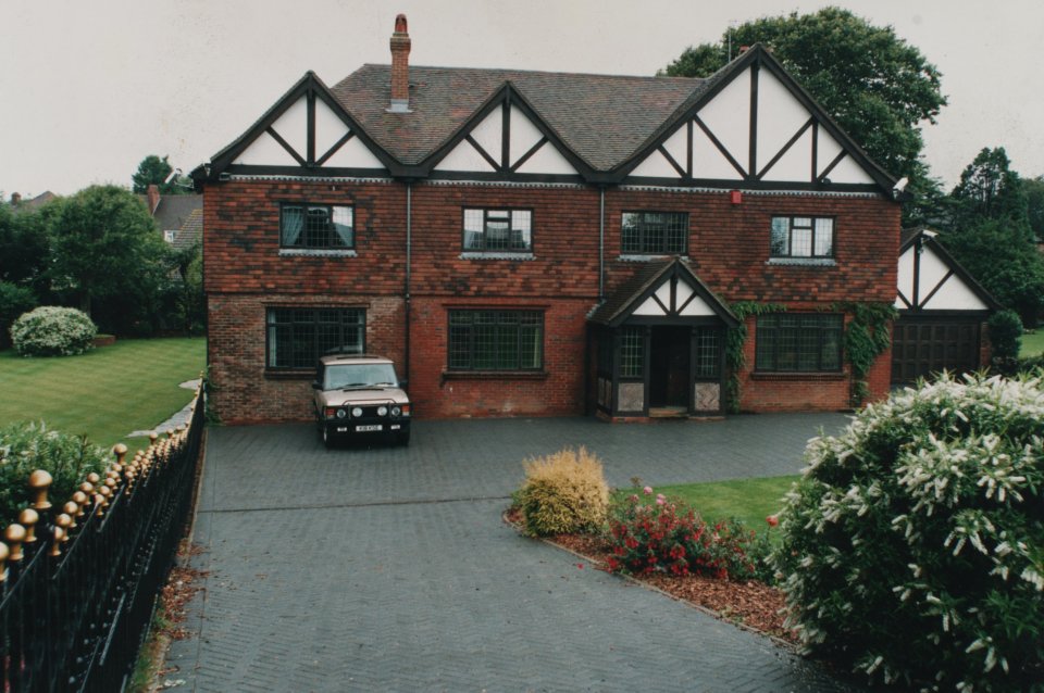 a brick house with a car parked in front of it