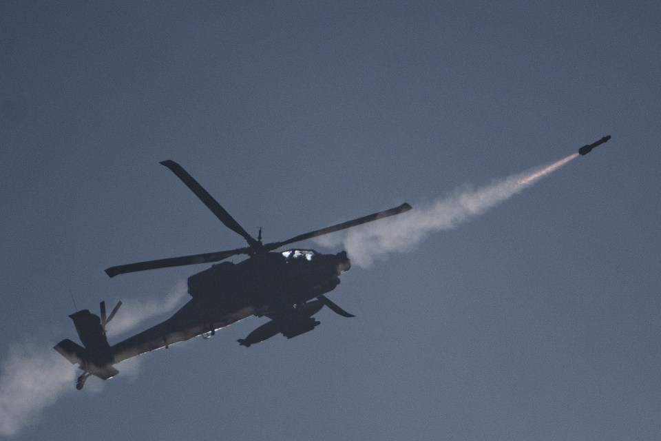 An Israeli Apache helicopter fires a missile towards southern Lebanon