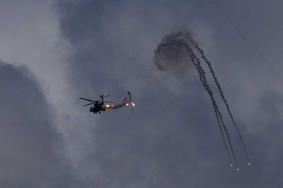 An Israeli Apache helicopter releases flares near the Lebanon border