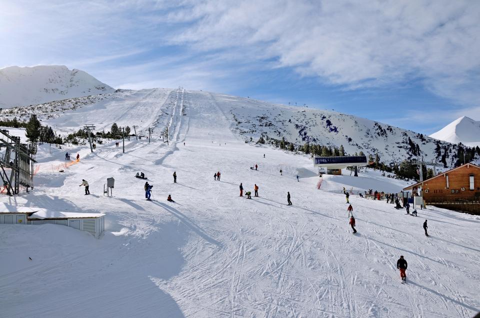 a group of people skiing down a snow covered slope