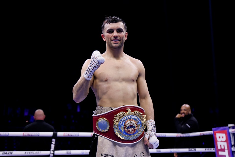 a boxer with a belt that says heavyweight on it