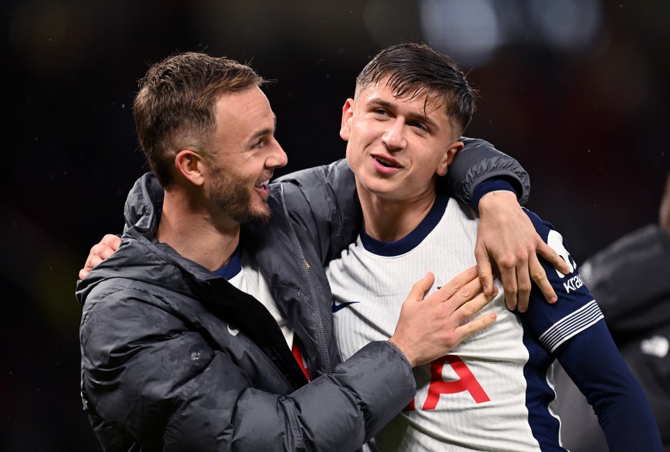 two men are hugging and one has the letter a on his shirt