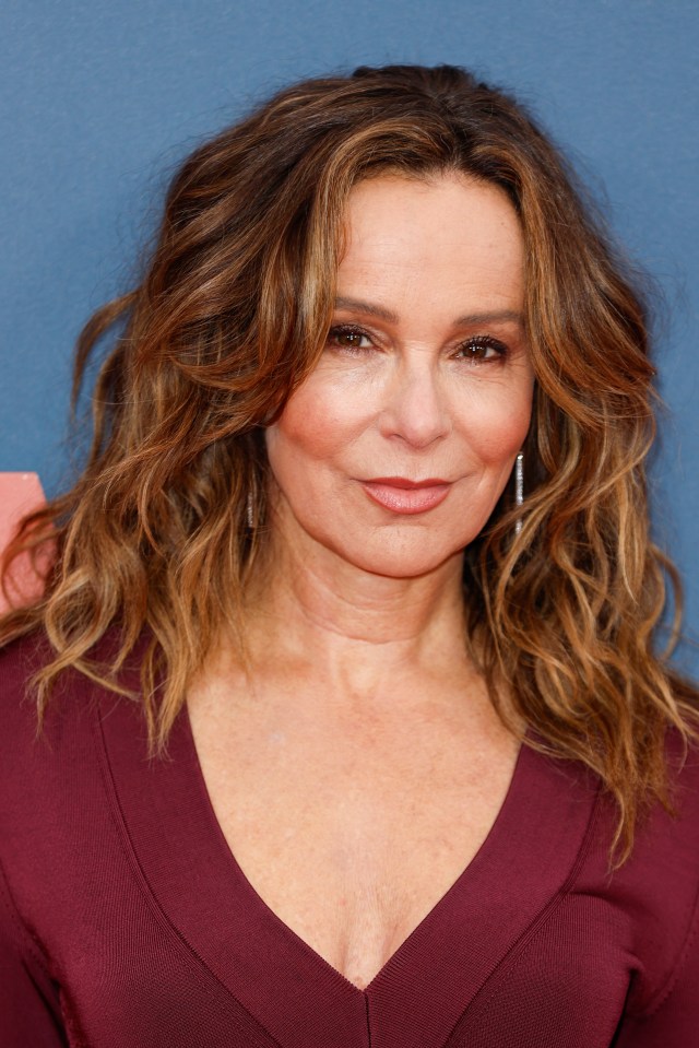 a close up of a woman 's face with a plunging neckline