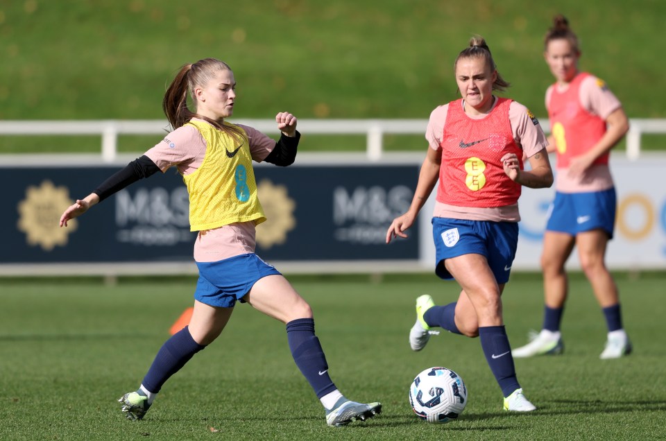 a female soccer player wearing a yellow vest with the number 6 on it