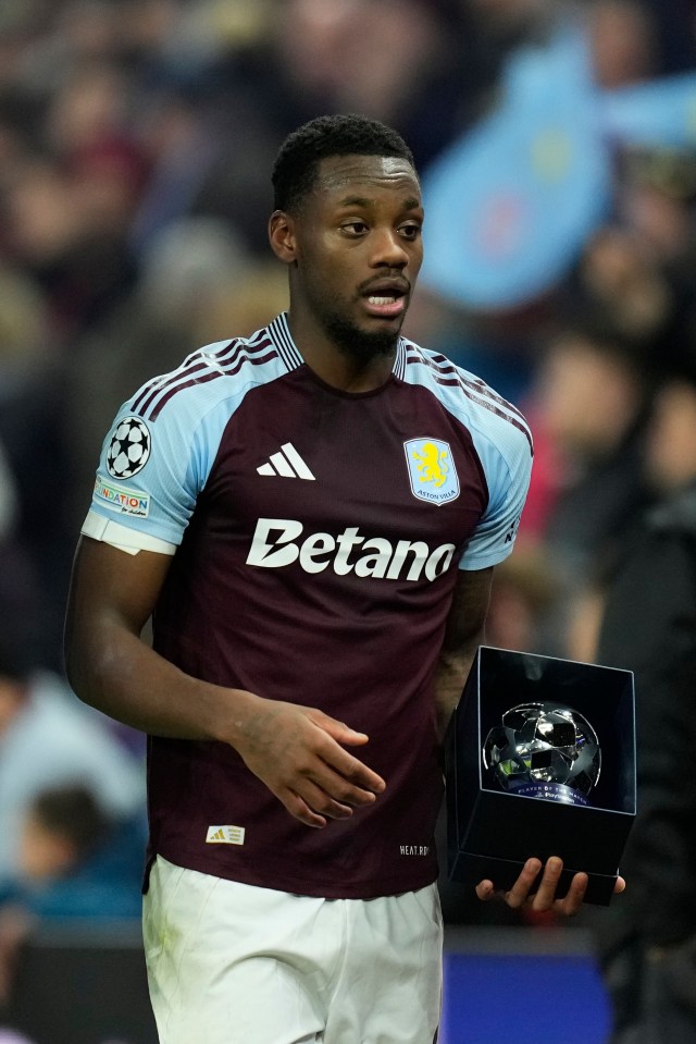 a soccer player in a betano jersey holds a trophy