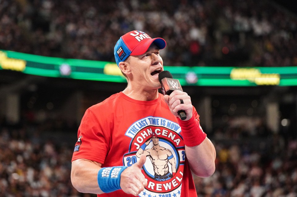 a man wearing a red shirt that says john cena on it