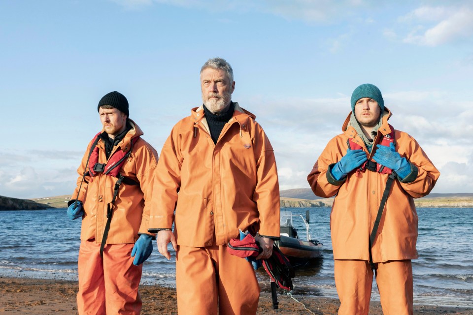 Vincent Regan emerges from the river in a dinghy