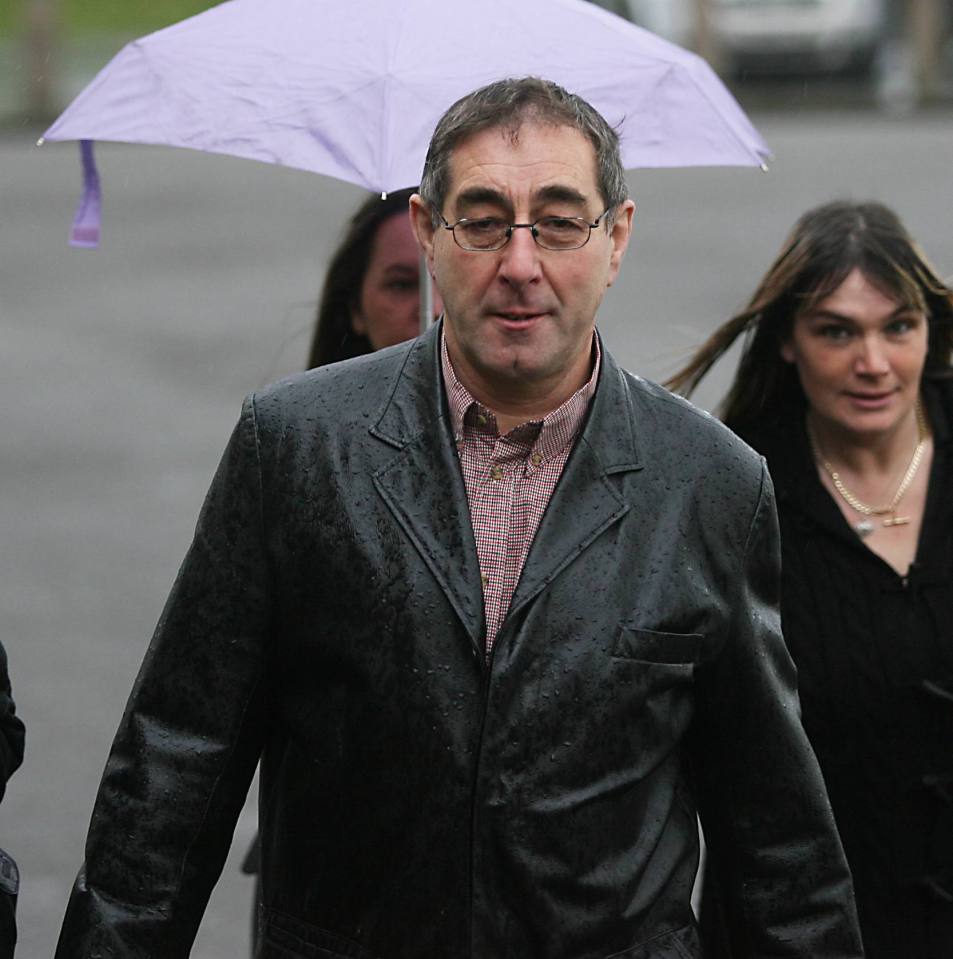 a man in a leather jacket holding a purple umbrella