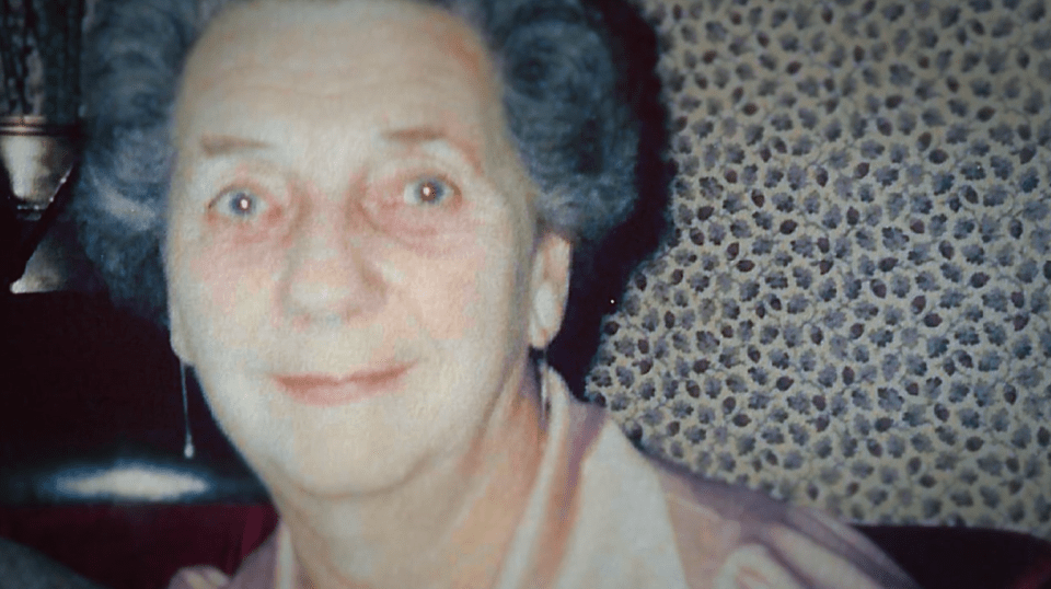 a close up of a woman 's face with a leopard print wallpaper in the background