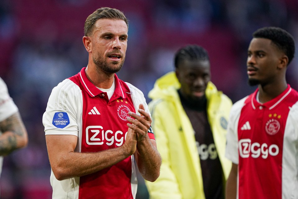 a soccer player wearing a ziggo jersey applauds