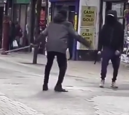 One thug swung his blade at his rival before he backed off