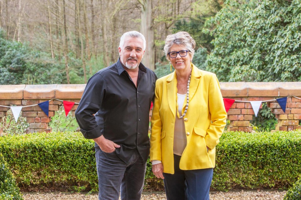 a man in a black shirt and a woman in a yellow jacket stand next to each other