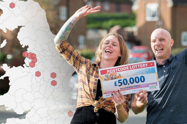 a man and woman holding a postcode lottery cheque