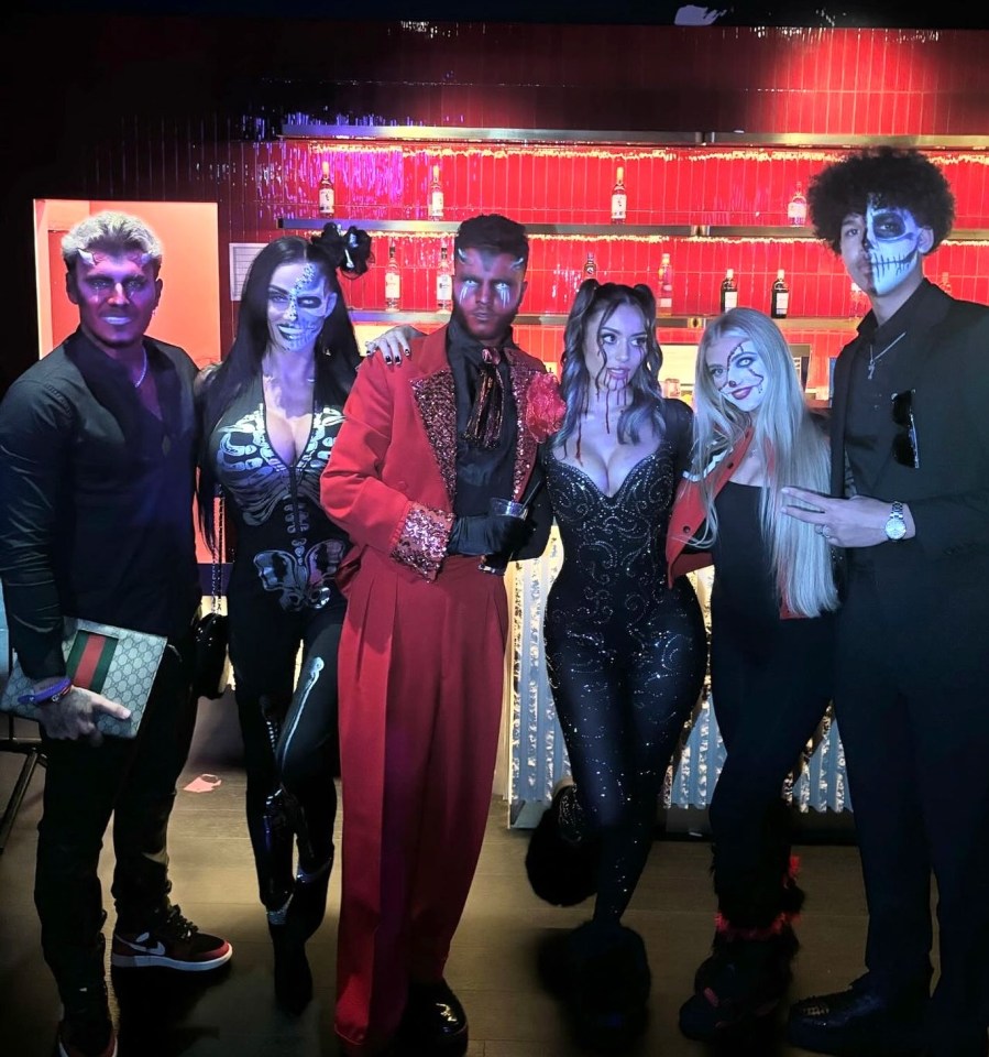 a group of people in halloween costumes pose for a photo