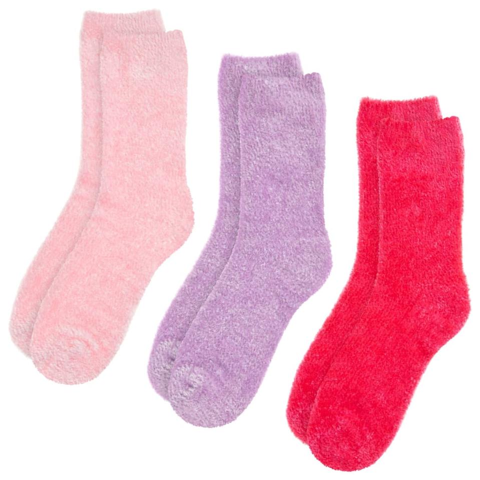 a pair of pink socks next to a pair of purple socks and a pair of red socks