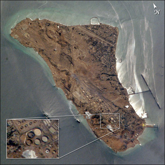 an aerial view of a large island with a compass pointing to the north