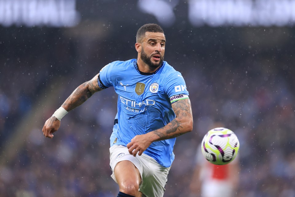 a soccer player wearing a blue shirt with the word city on it