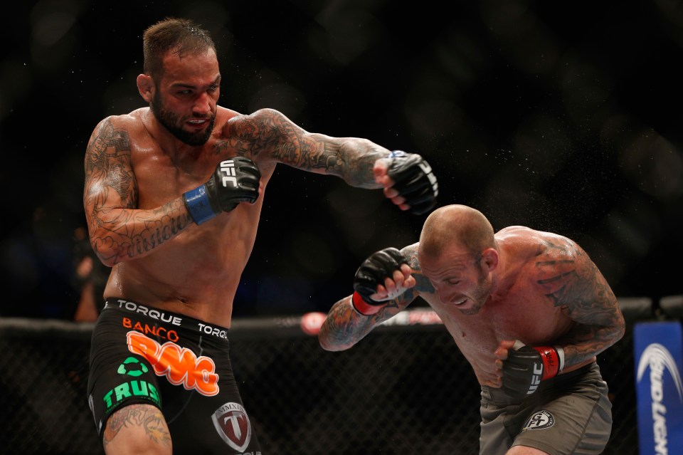 Vasconcelos punches Luke Zachrich in their middleweight fight at UFC 175