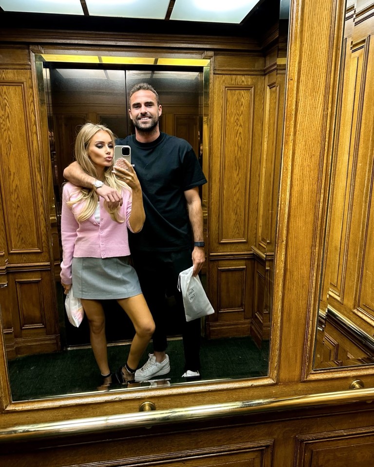 a man and a woman are taking a selfie in an elevator