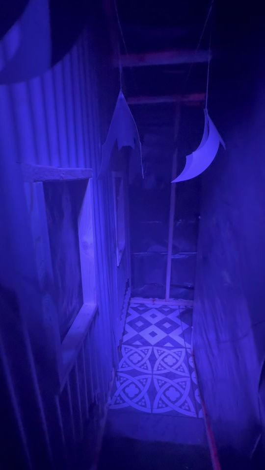 Inside the creepy house is lit up with blue lights