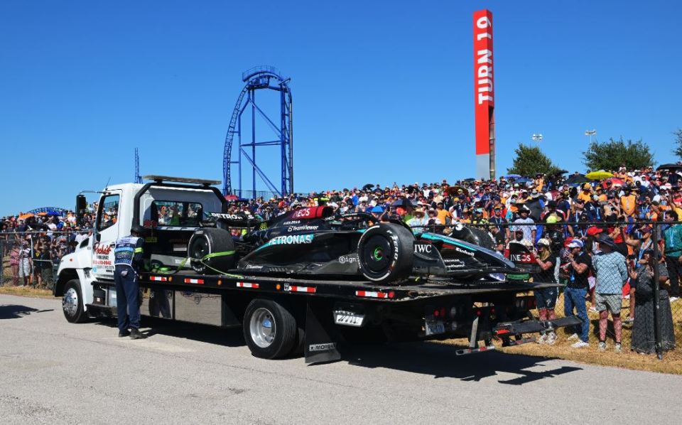 a tow truck with a petronas car on the back