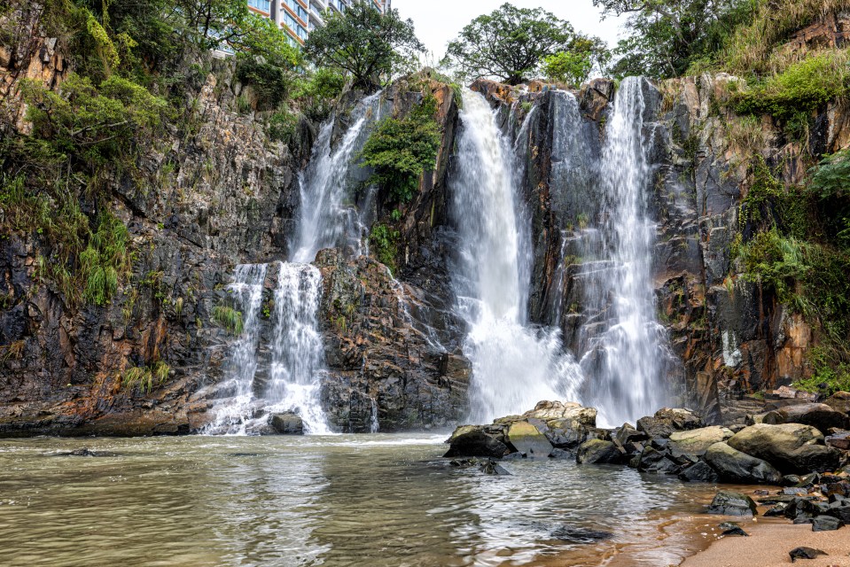 a waterfall that is surrounded by trees and rocks