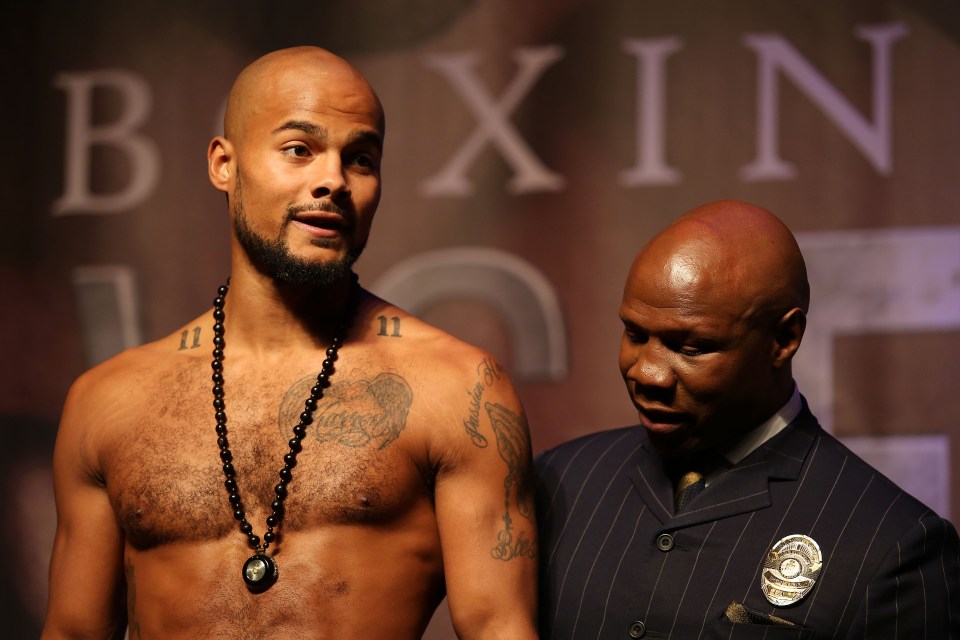 a man with tattoos on his chest stands next to a man in a suit in front of a sign that says boxing