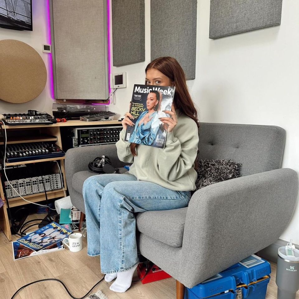 The star showed a magazine cover as she posed with recording equipment in the background.