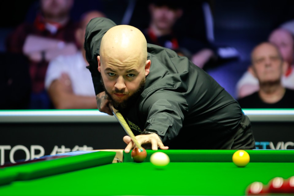 a man playing snooker with the word top in the background