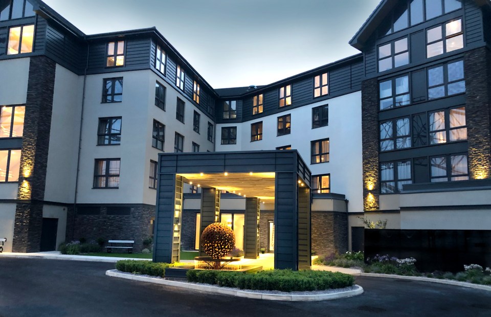 a large building with lots of windows is lit up at night