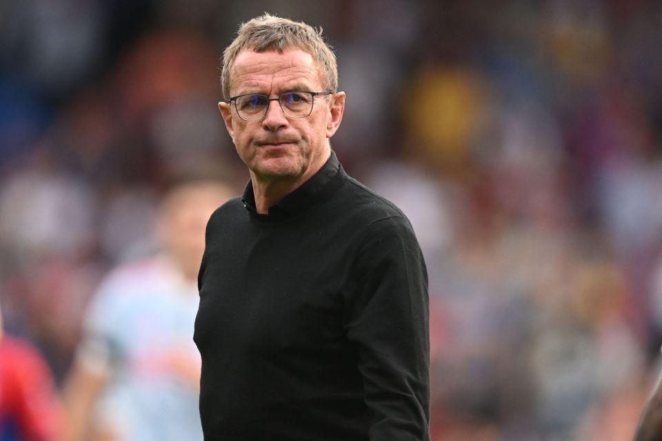 a man wearing glasses and a black shirt stands on a field