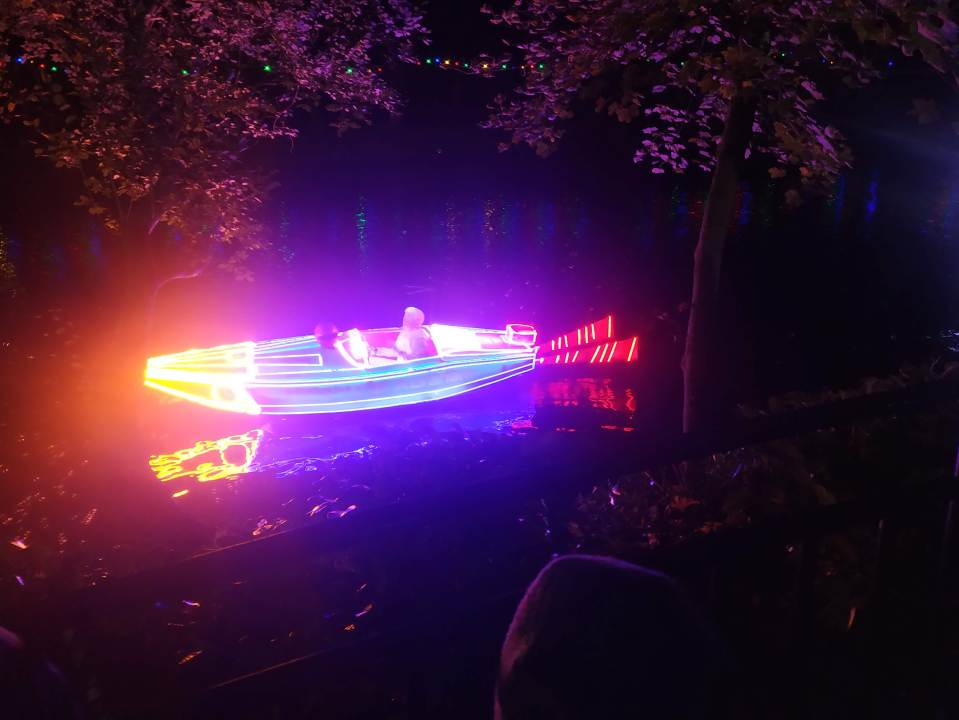 a boat is lit up with purple and orange lights