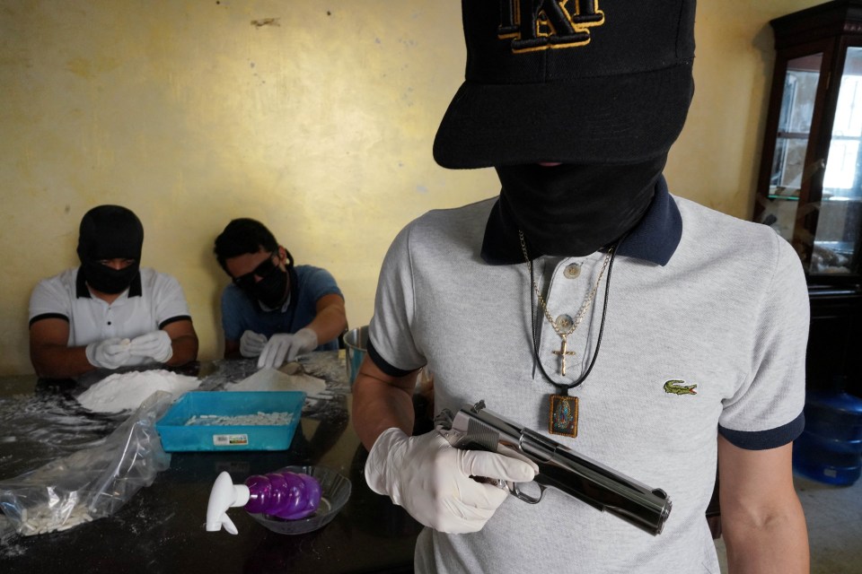 A member of the Sinaloa Cartel who identifies himself as Guero poses for a photo in a safe house in Culiacan, Mexico