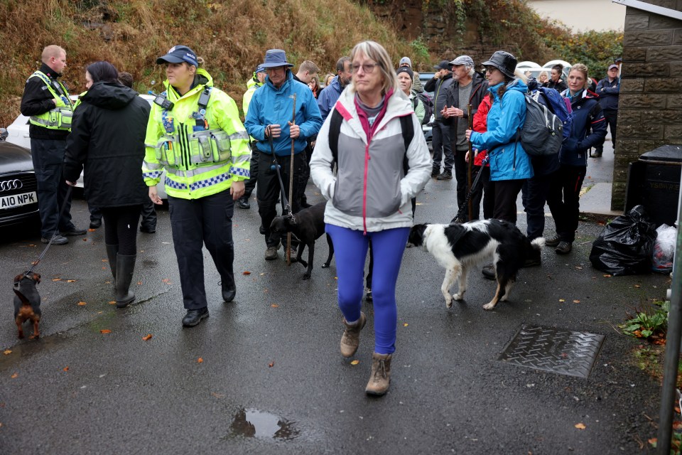 a group of people walking with a police officer in a yellow vest