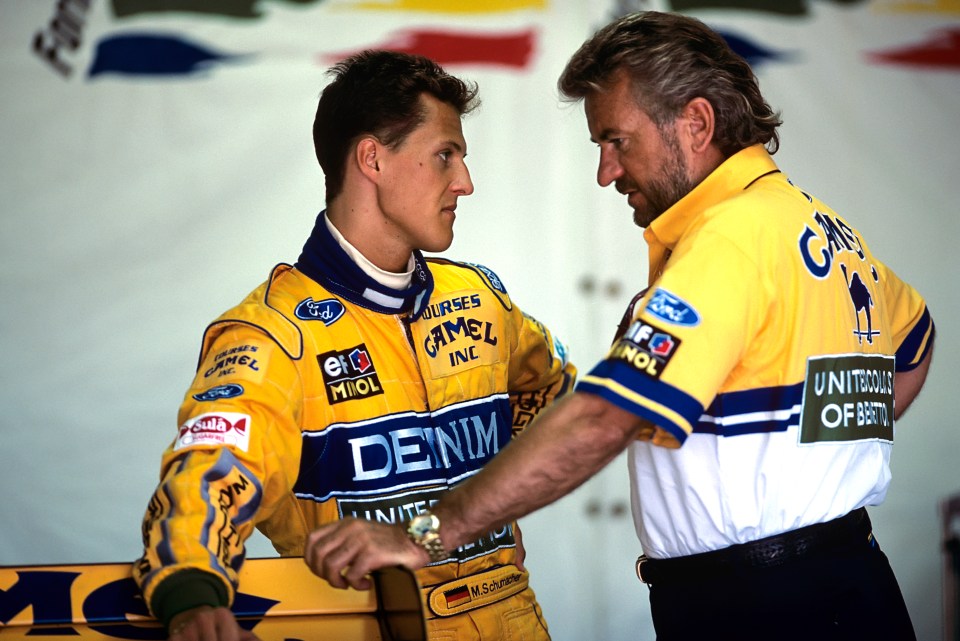 a man in a yellow denim jacket talks to another man