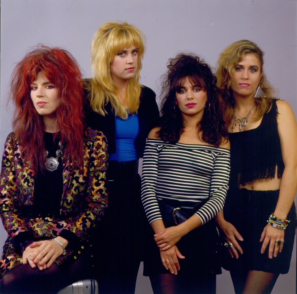 a group of four women posing for a picture