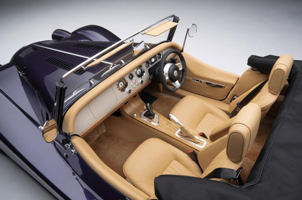 a purple car with tan seats and a steering wheel