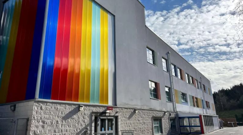 a building with a rainbow of colors on the side of it