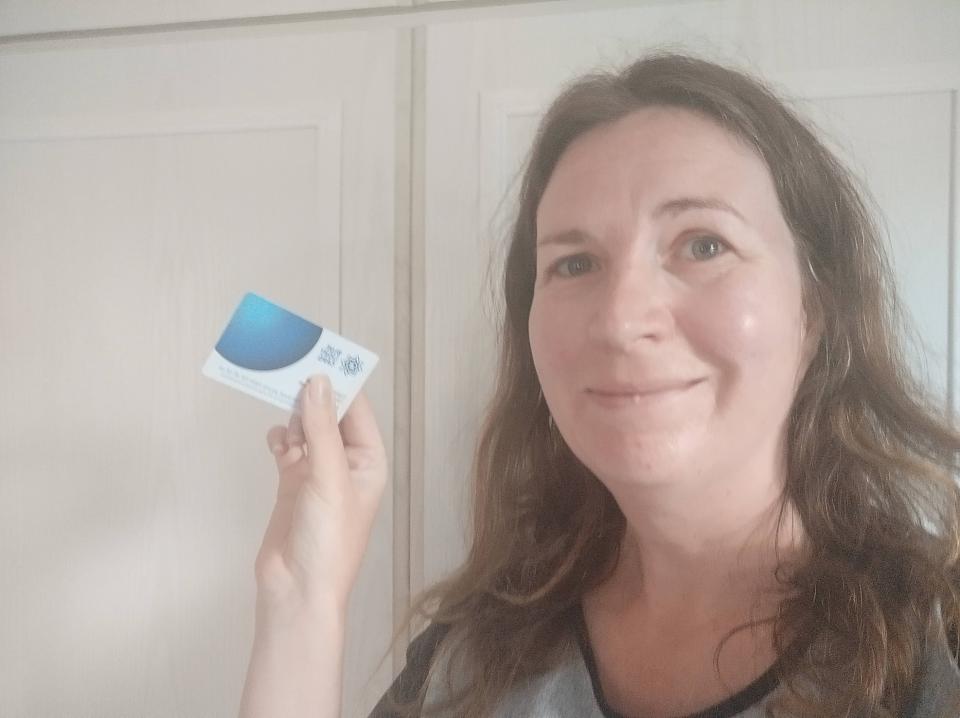 a woman holds up a card that says ' scottish council ' on it