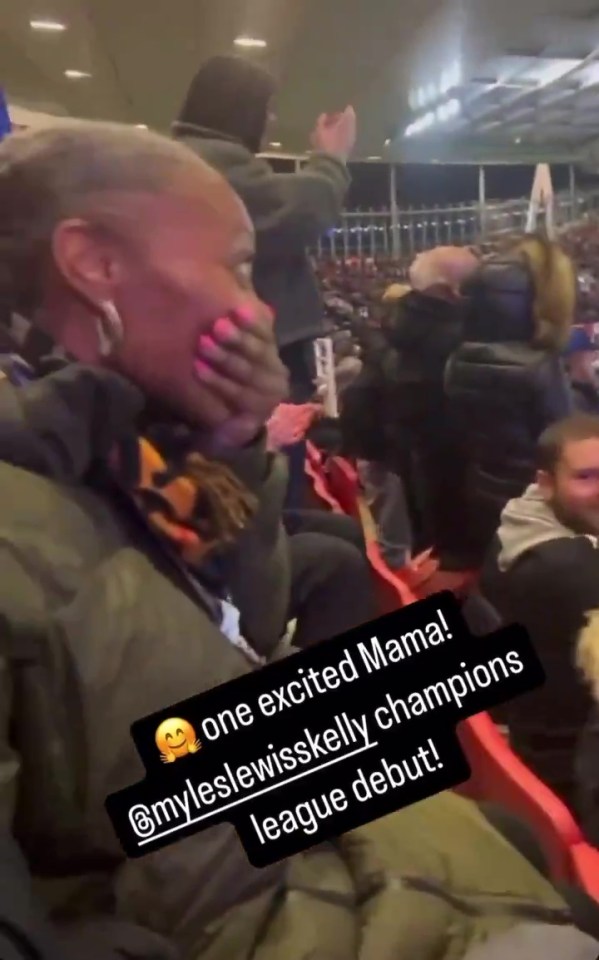 a woman is sitting in a stadium with her hand on her face .