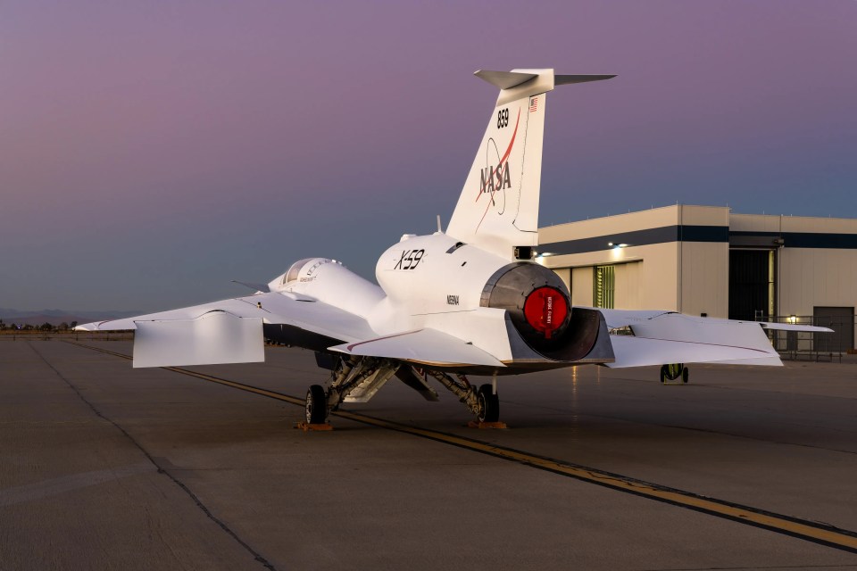 a nasa jet sits on a runway at sunset