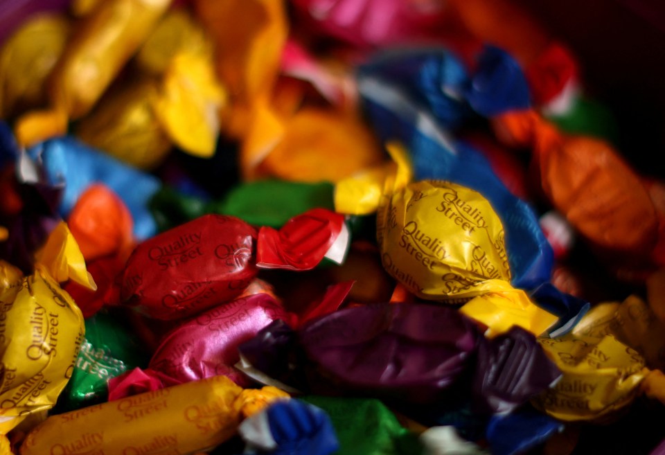 a pile of quality street candies in various colors