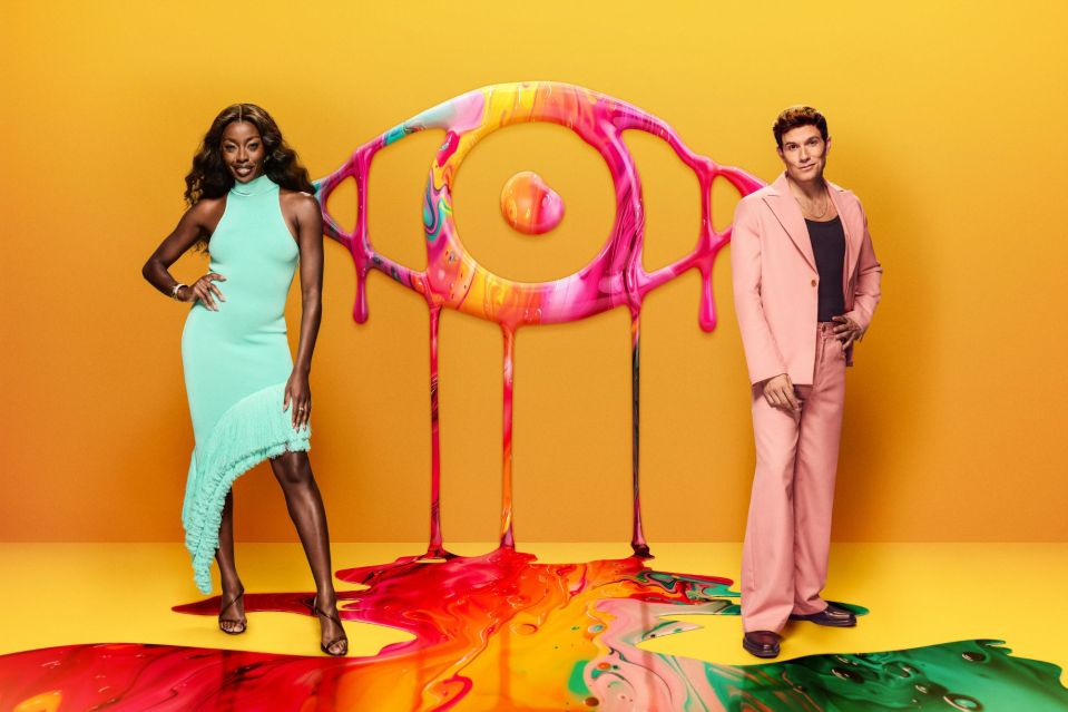 a man in a pink suit stands next to a woman in a blue dress