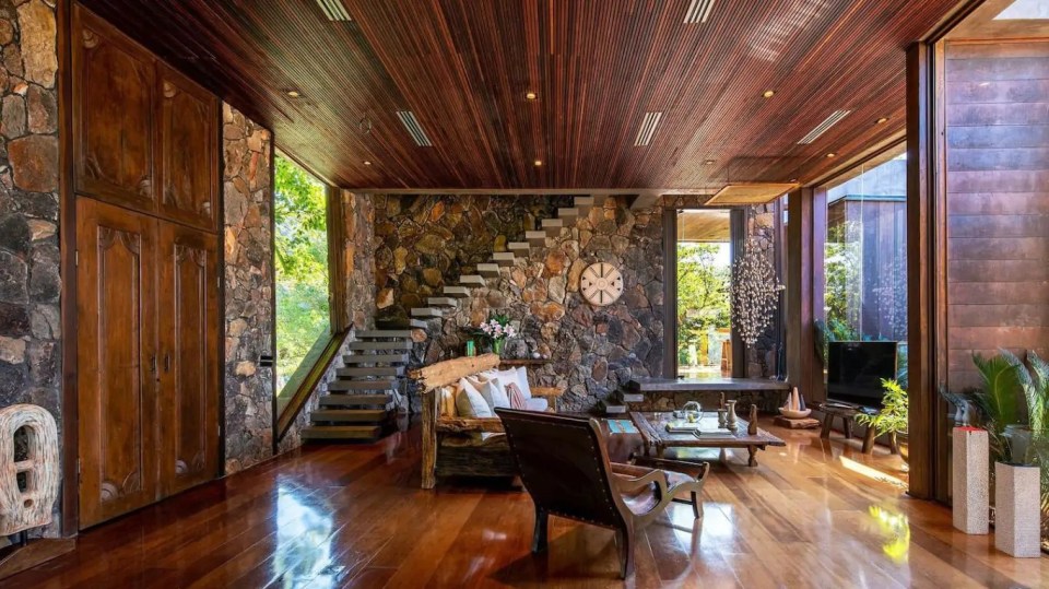 a living room with wooden floors and a clock on the wall